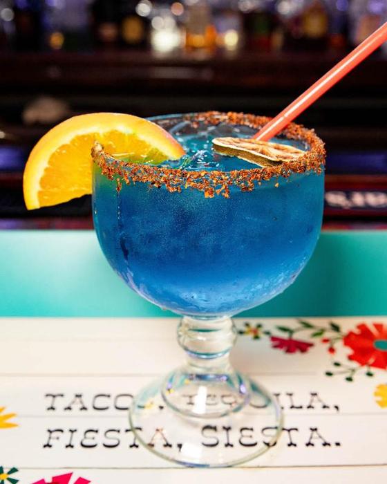 A blue margarita with a chile-salt rim