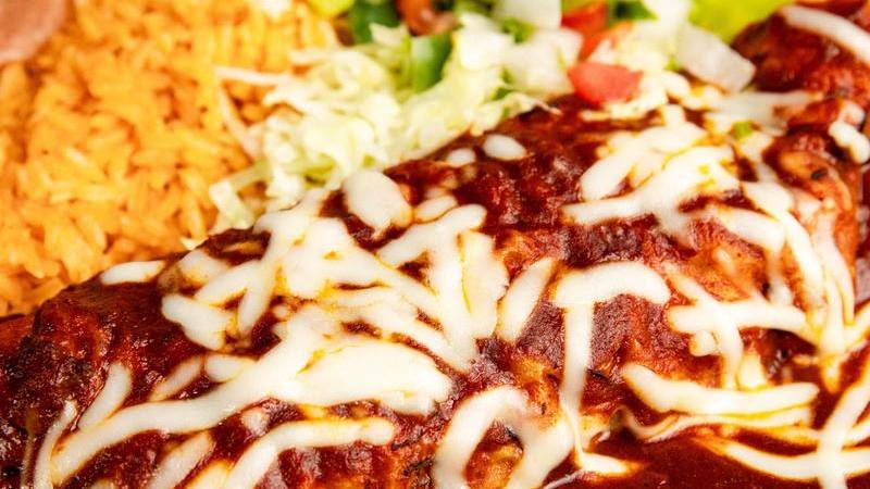 Cheese-topped enchiladas in red chile sauce with rice
