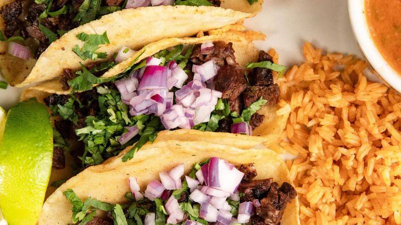 Asada street tacos on corn tortillas with onion and cilantro