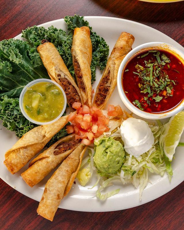 Birria flautas with consomme, guacamole and sour cream