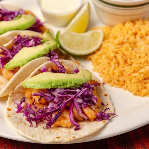 Fish tacos with purple cabbage, avocado and lime