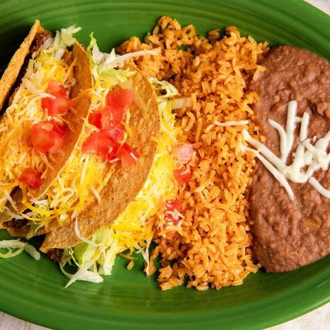 Crispy beef tacos with rice and refried beans