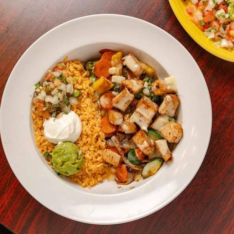 A Mexi-Bowl of grilled chicken, rice, guacamole and sour cream
