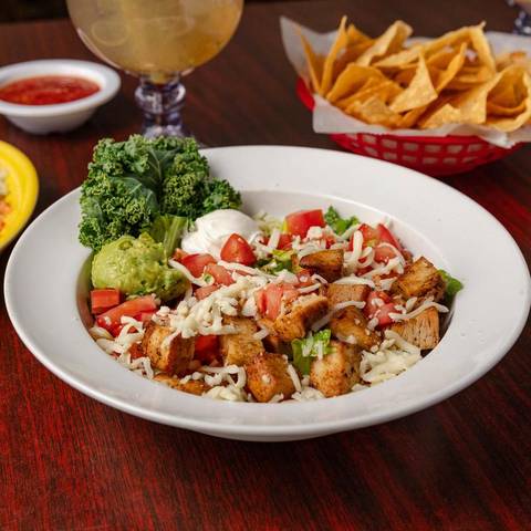 Grilled salad with chicken, tomatoes, cheese, sour cream and guacamole