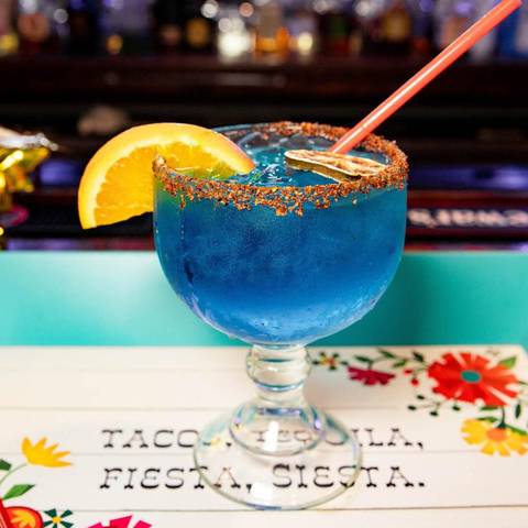 A blue margarita with a chile-salt rim